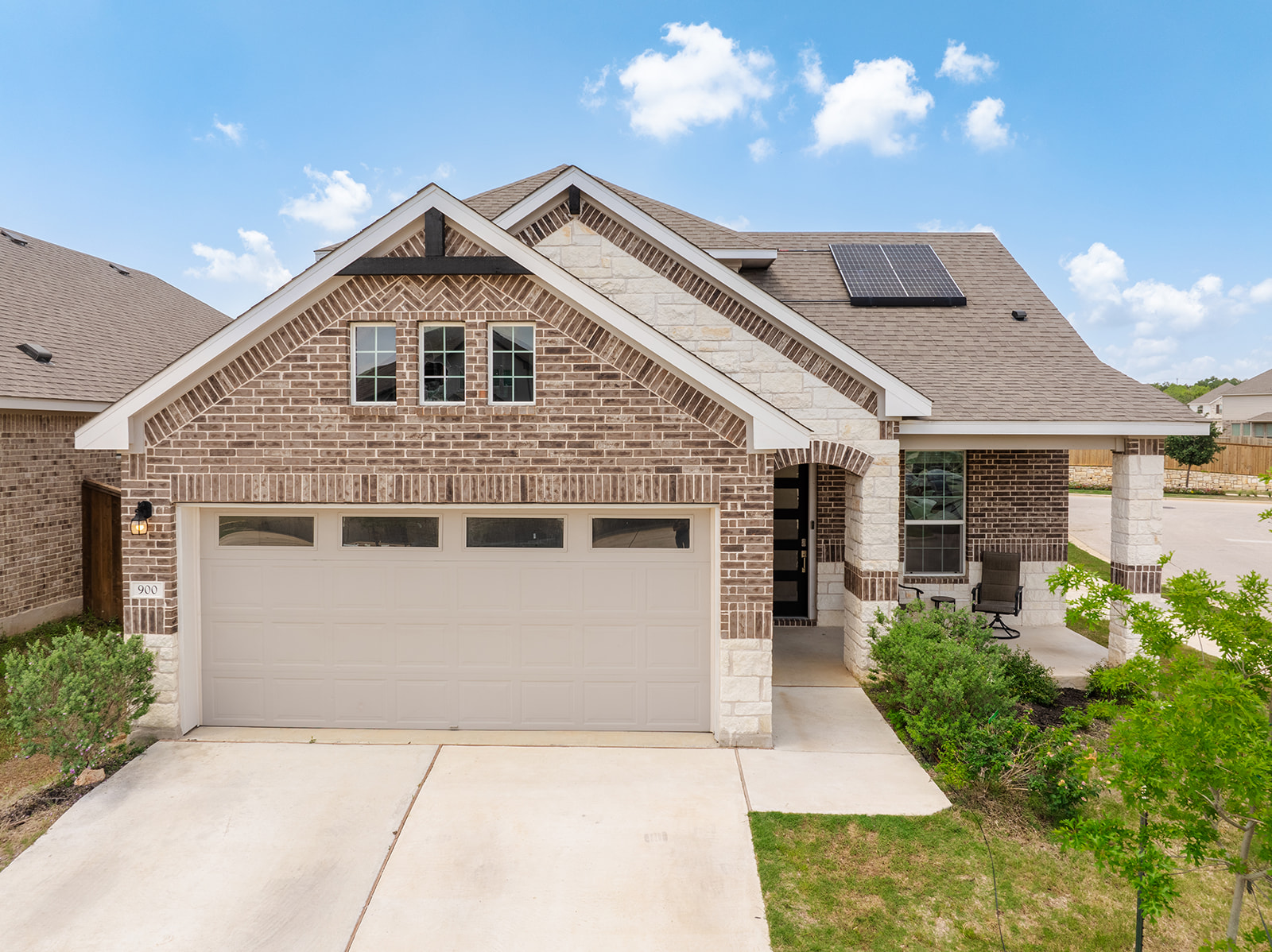 900 Balsora Cove Georgetown, TX 78628 - Photo 1 of 39 Elegant brick and stone facade welcomes guests to this charming residence with an inviting front porch.