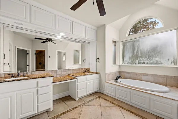 a view of a kitchen with white cabinets