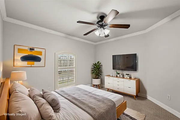 a bedroom with a bed and a painting on the wall