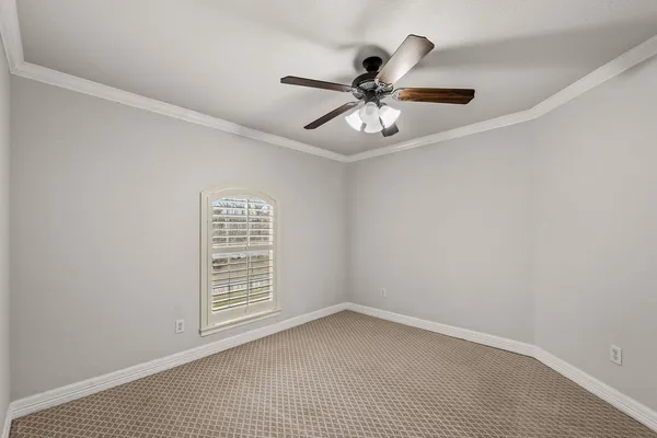 a view of a livingroom with a ceiling fan and window