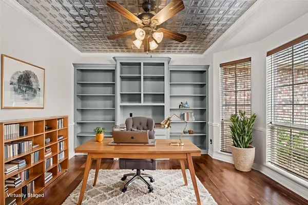 a bedroom with a bed a chandelier and a potted plant
