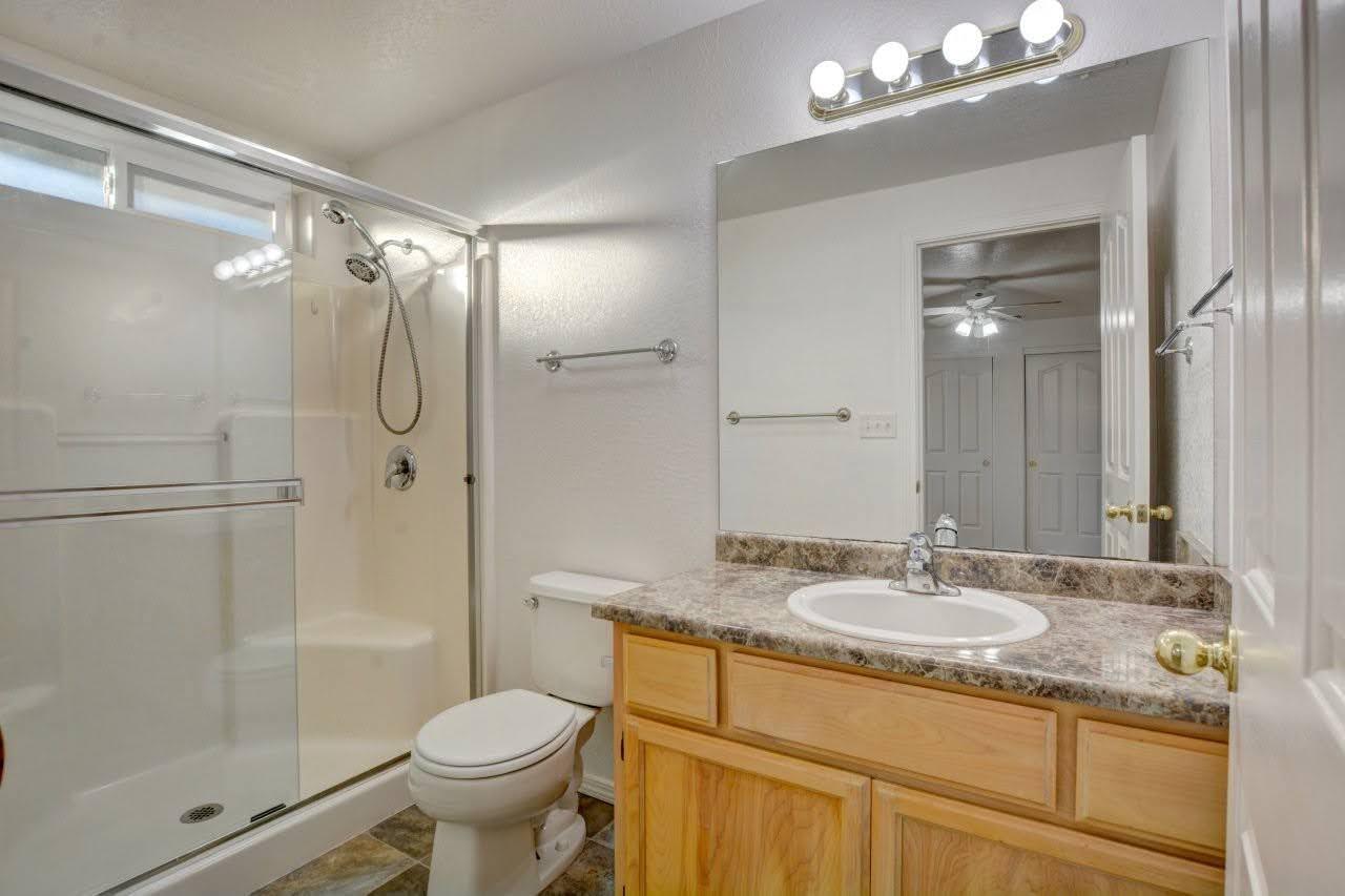 417 Crystal Drive Eagle Point, OR 97524 - Photo 19 of 35 a bathroom with a granite countertop sink toilet and shower