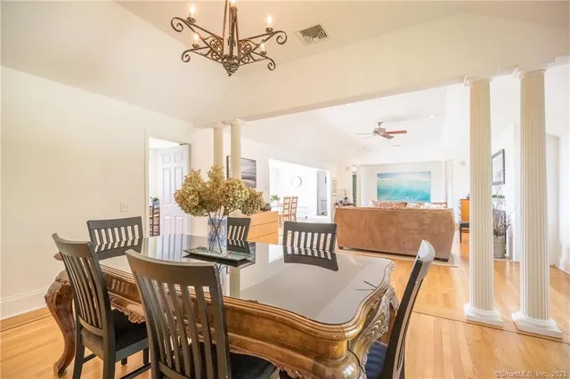 a view of a dining room with furniture and a chandelier