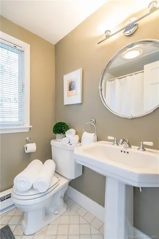 a bathroom with a sink a mirror and a toilet