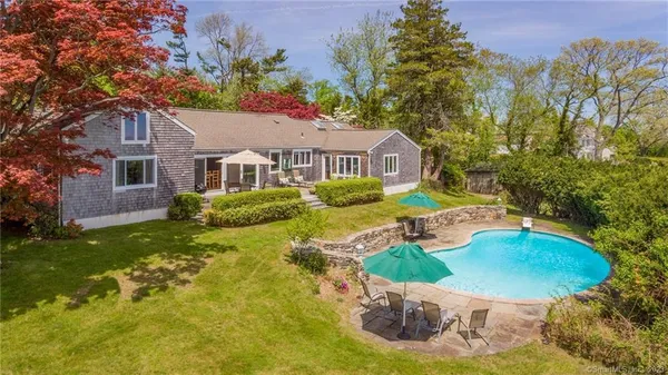 a house with swimming pool in front of it