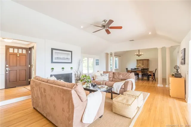 a living room with furniture and a wooden floor