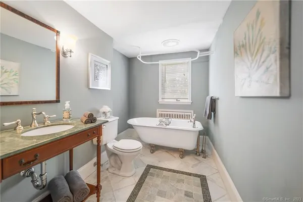 a bathroom with a sink toilet and mirror