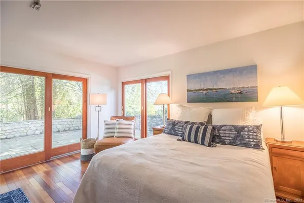 a bedroom with a large bed and a large window
