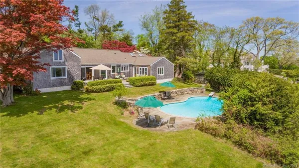 a front view of house with yard and trees
