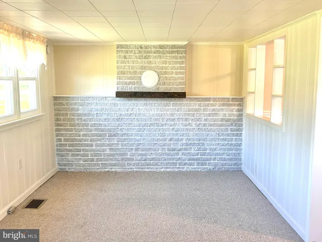 a view of an empty room and a window