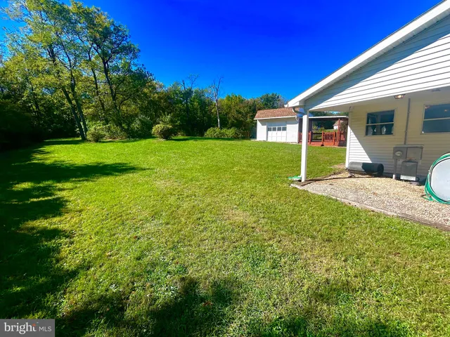 a view of a house with a yard porch and sitting area