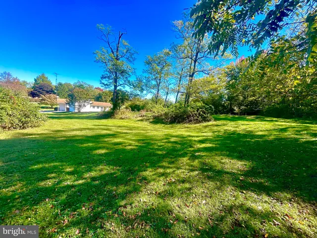 a view of a big yard with a house