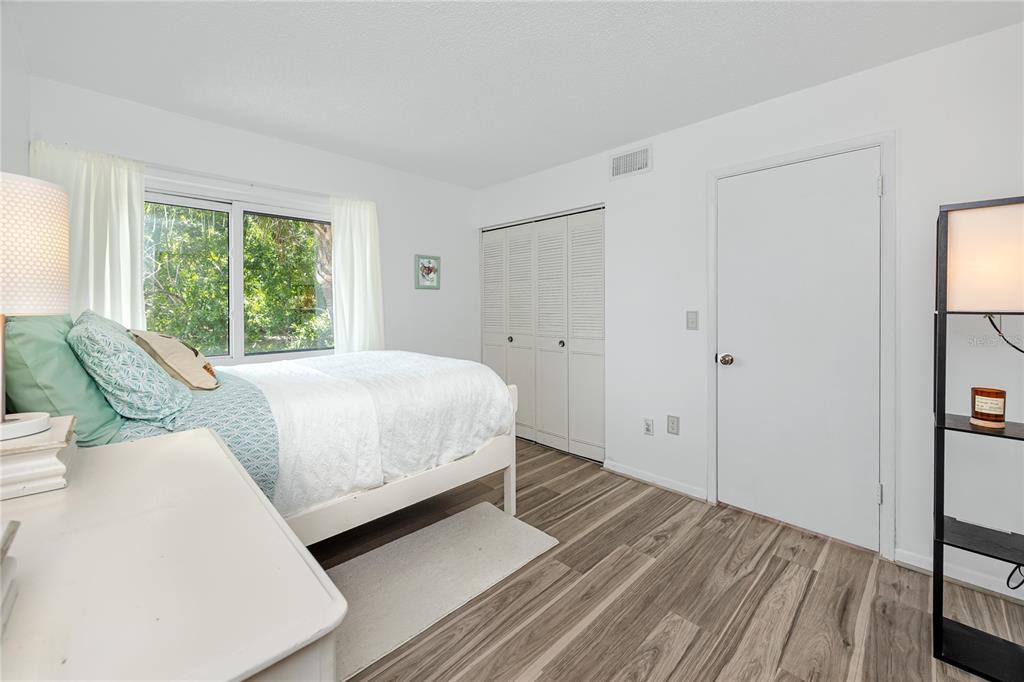 2207 Belleair Road, Unit B30 Clearwater, FL 33764 - Photo 24 of 39 a bed room with a bed and a large window