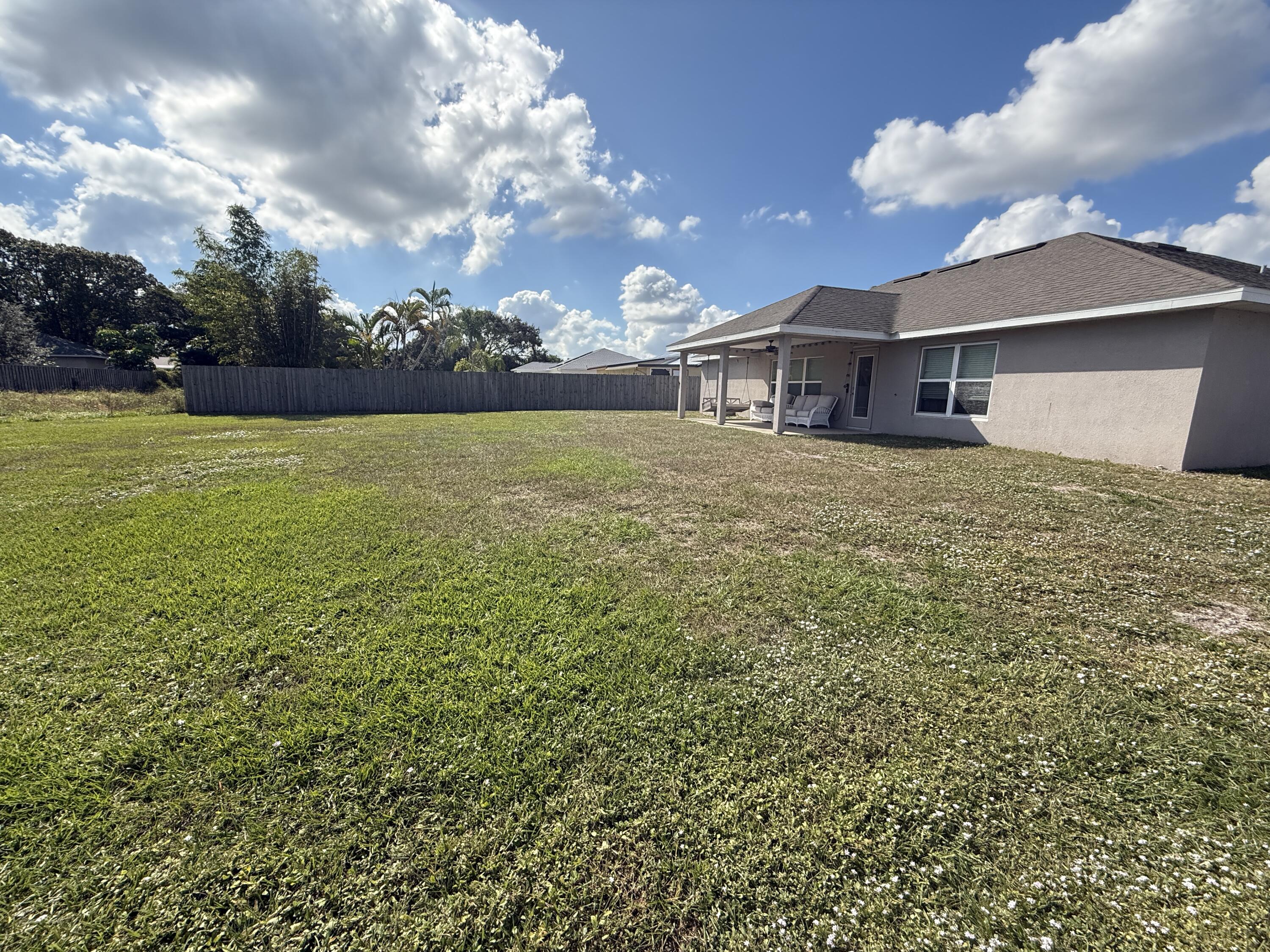 2177 Southeast Dolphin Road Port St. Lucie, FL 34952 - Photo 11 of 16 a view of a house with a yard