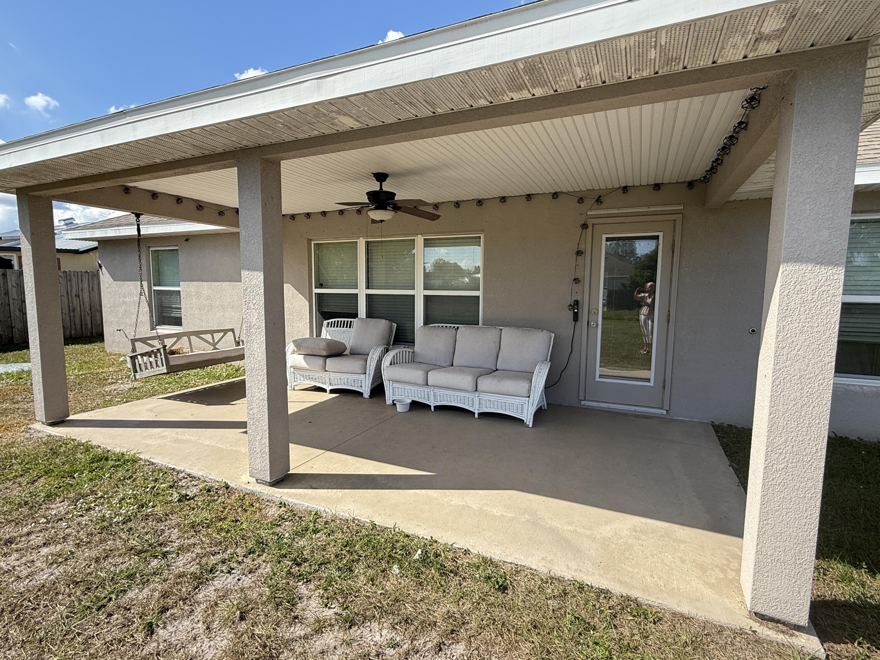 2177 Southeast Dolphin Road Port St. Lucie, FL 34952 - Photo 12 of 16 a living room with furniture and a floor to ceiling window