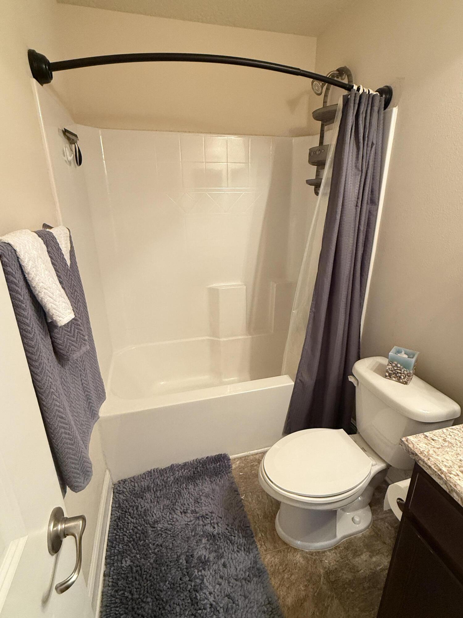 2177 Southeast Dolphin Road Port St. Lucie, FL 34952 - Photo 15 of 16 a bathroom with a toilet and a shower