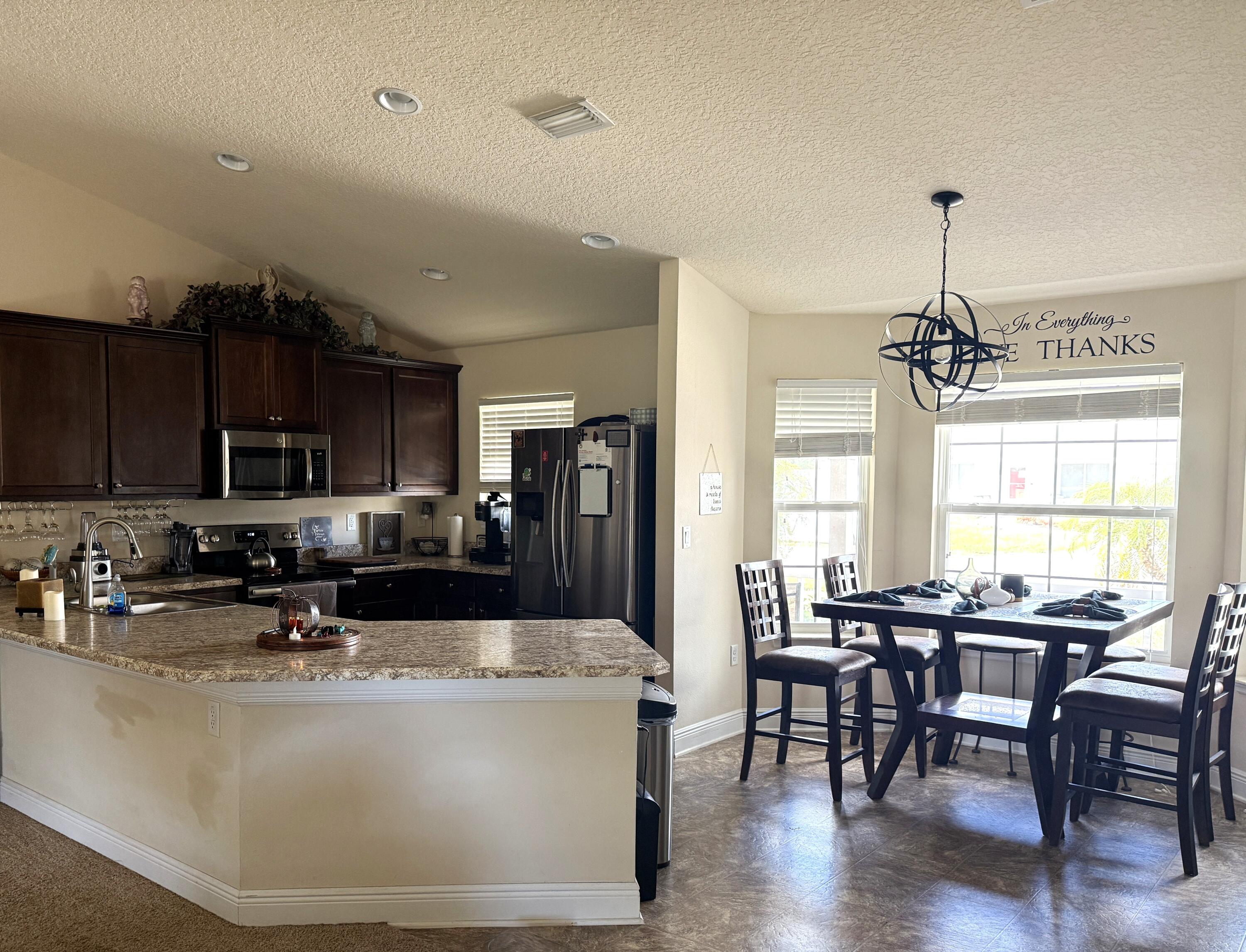 2177 Southeast Dolphin Road Port St. Lucie, FL 34952 - Photo 4 of 16 a view of a dining room with furniture window and wooden floor