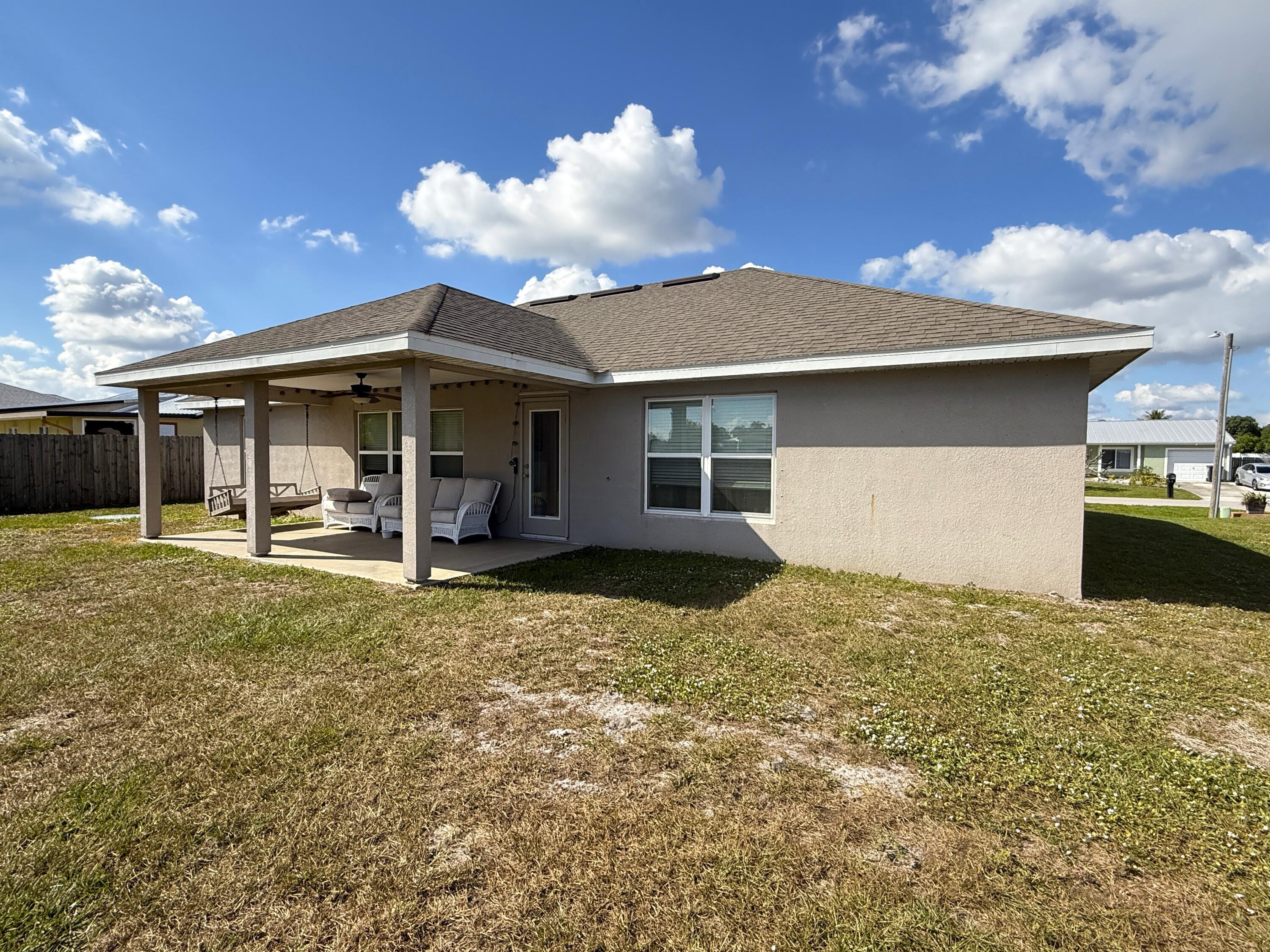 2177 Southeast Dolphin Road Port St. Lucie, FL 34952 - Photo 10 of 16 a view of a house with a backyard