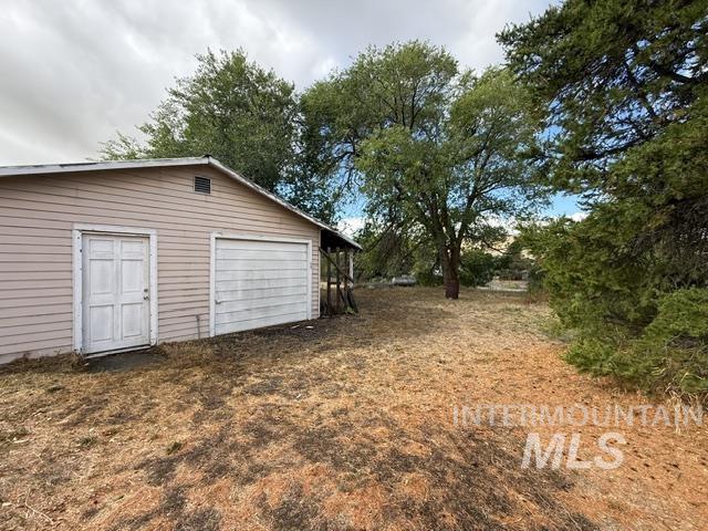 555 Cemetery Road Cambridge, ID 83610 - Photo 23 of 41 Detached garage structure with horizontal siding and a single garage door