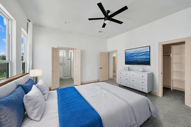 a bedroom with a bed and a flat screen tv