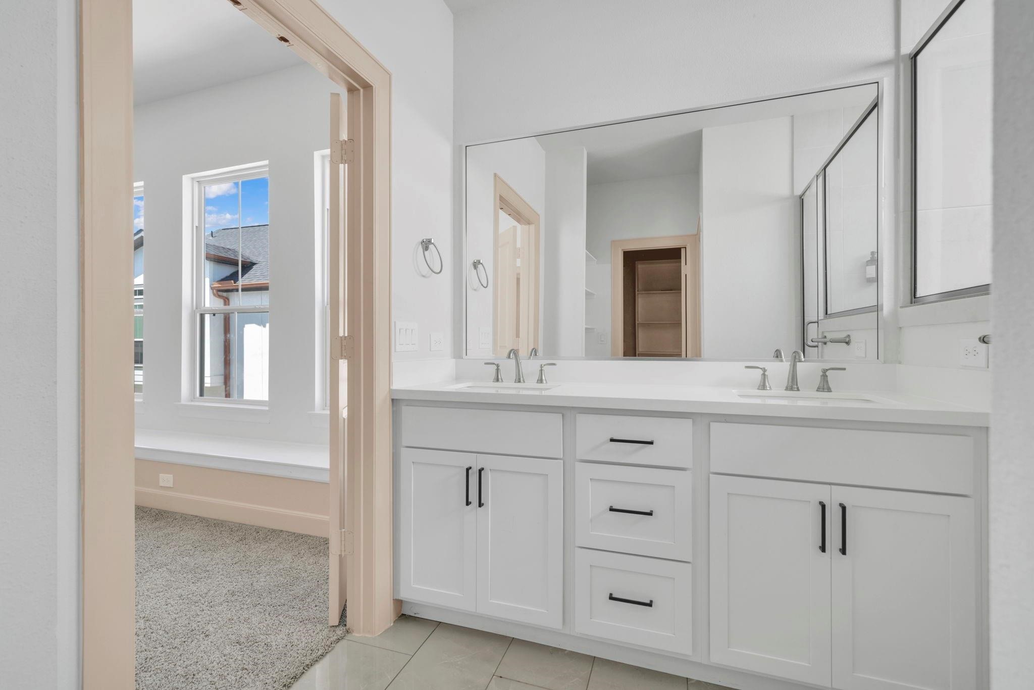 9551 Neuens Road, Unit B Houston, TX 77080 - Photo 16 of 32 a bathroom with double vanity sink and a mirror