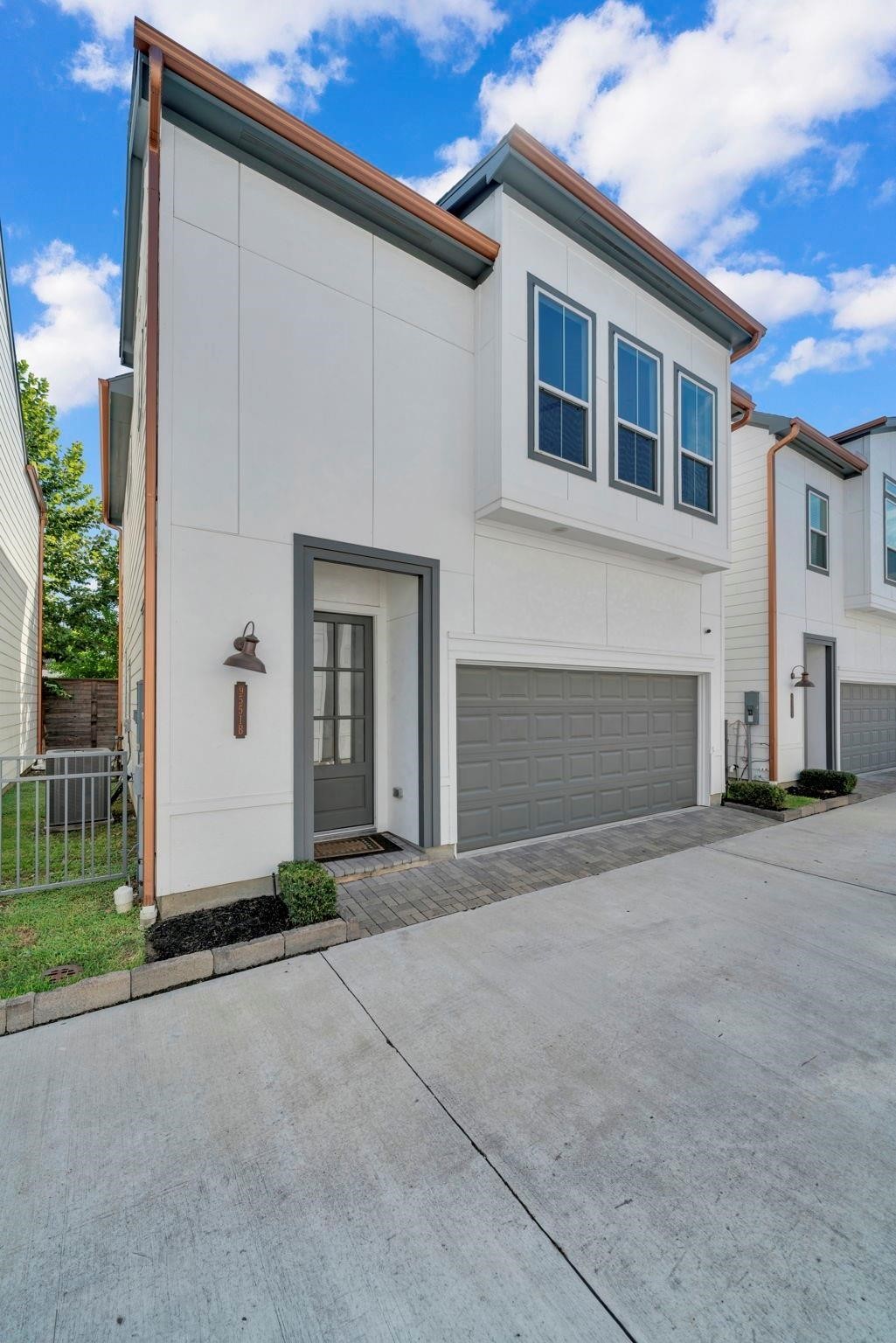 9551 Neuens Road, Unit B Houston, TX 77080 - Photo 2 of 32 a front view of a house with a yard and garage