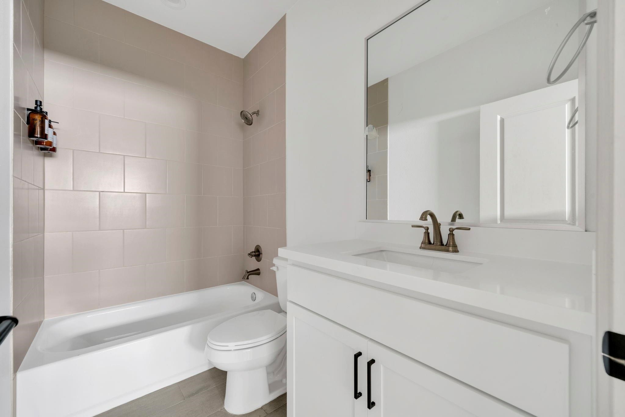 9551 Neuens Road, Unit B Houston, TX 77080 - Photo 25 of 32 a bathroom with a sink a toilet and shower