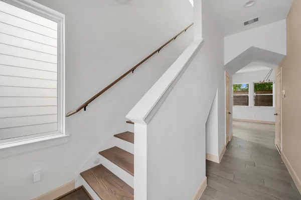 a view of entryway with wooden floor and stairs