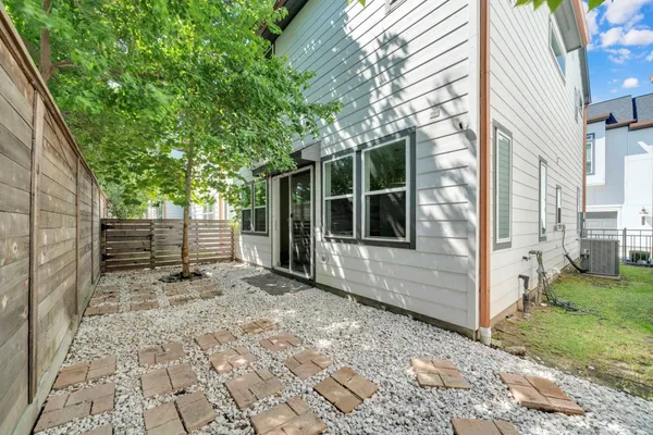 a view of a backyard with a large tree