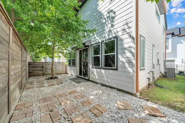 a view of a backyard with a large tree