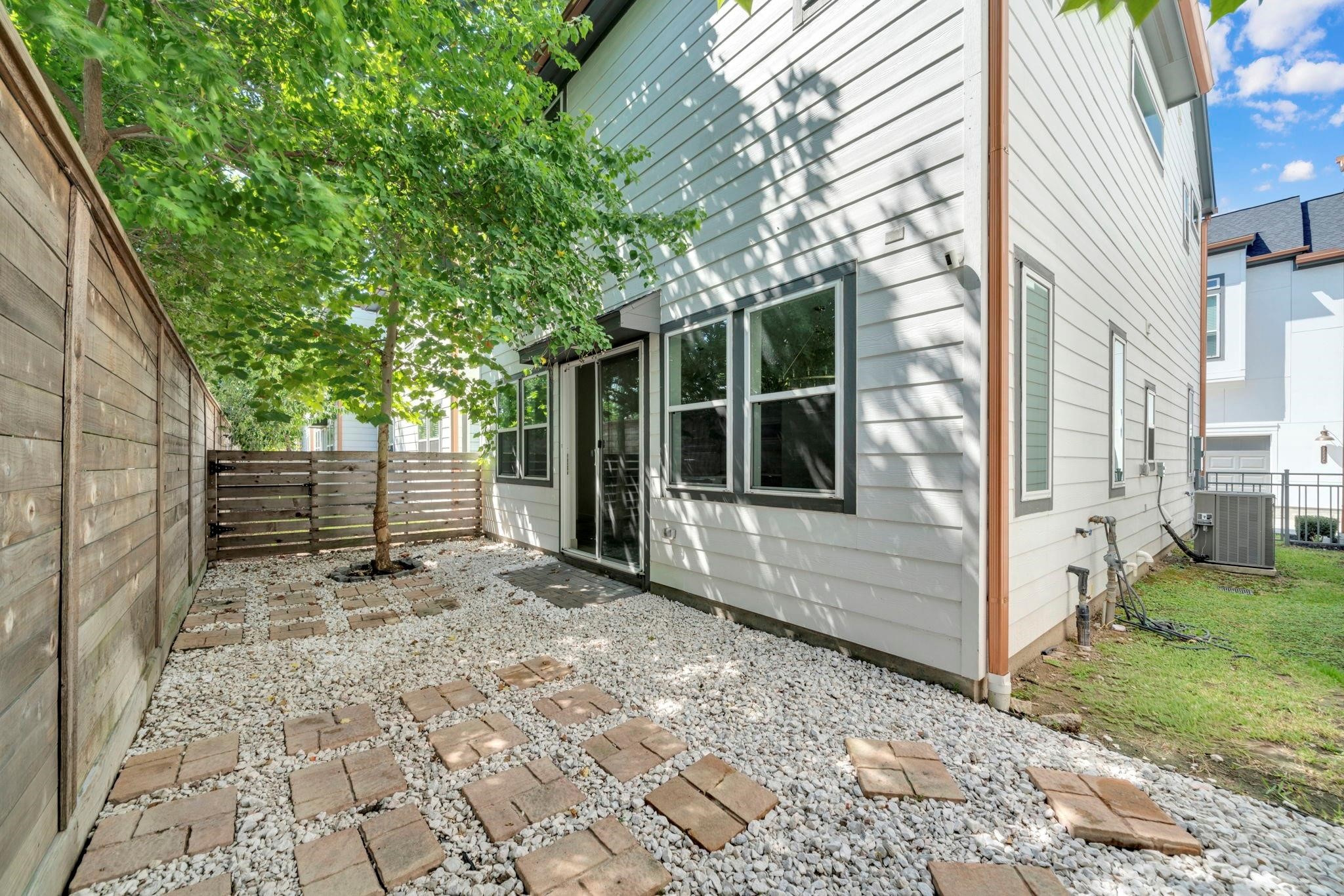 9551 Neuens Road, Unit B Houston, TX 77080 - Photo 5 of 32 a view of a backyard with a large tree