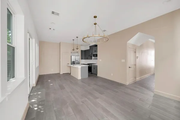 a view of a kitchen with wooden floor and a kitchen