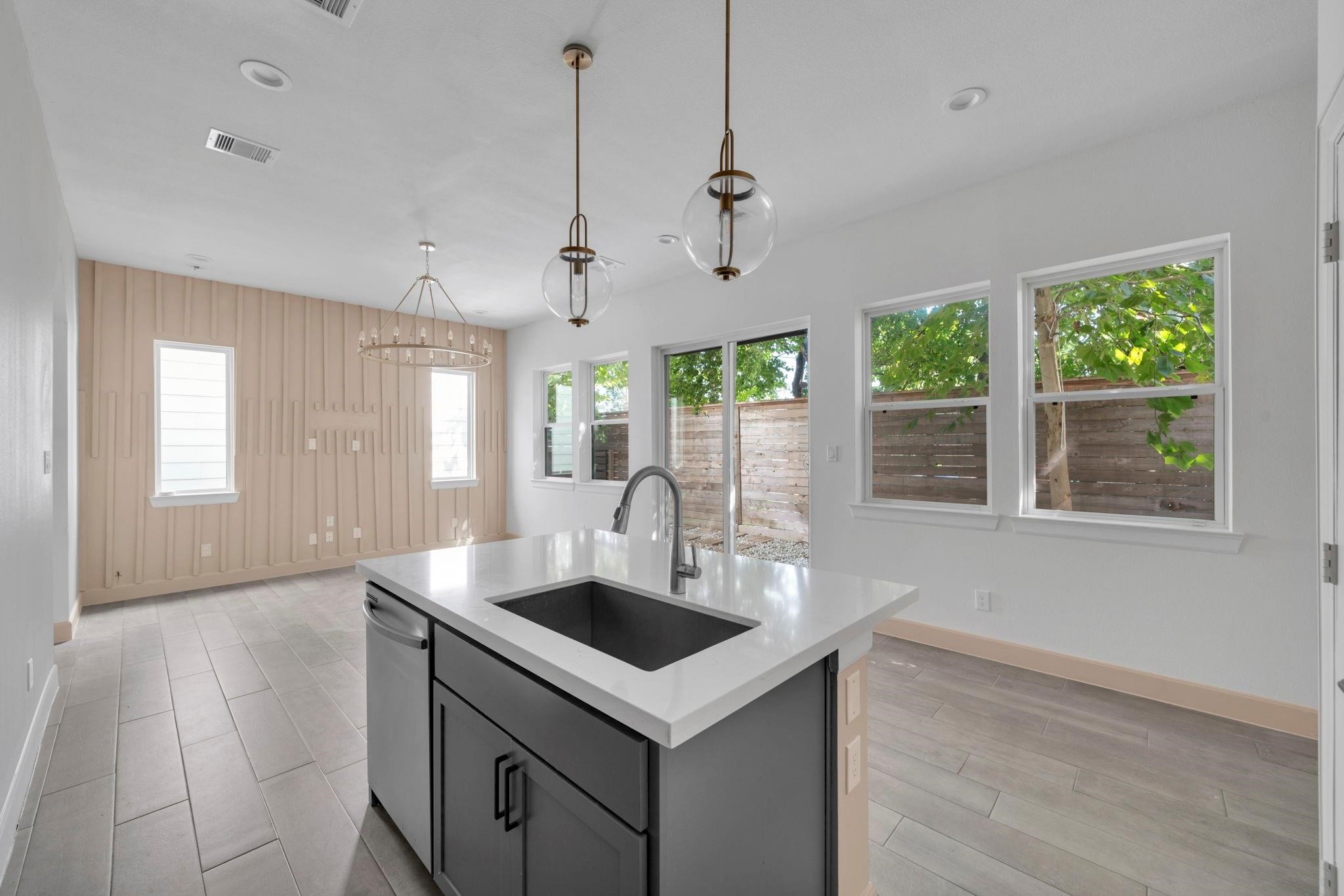 9551 Neuens Road, Unit B Houston, TX 77080 - Photo 10 of 32 a kitchen that has a sink a window and cabinets