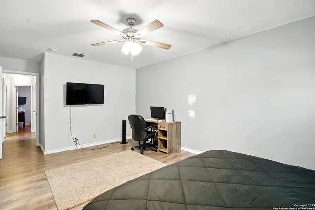 a bathroom with a granite countertop sink toilet and mirror