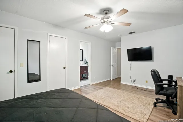a bathroom with a double vanity sink toilet and mirror
