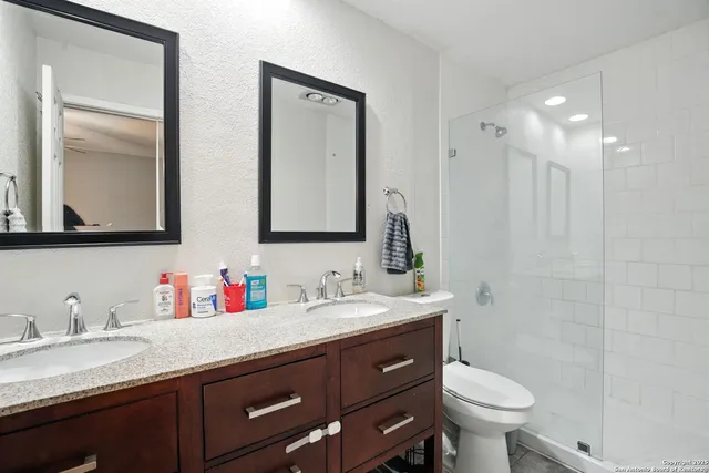 a living room with furniture a fireplace and a chandelier