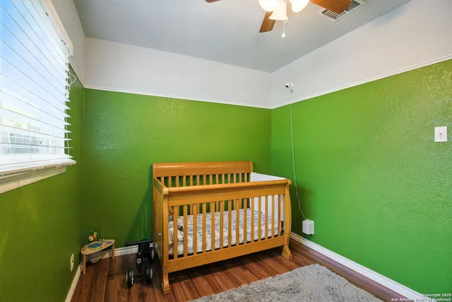 a bedroom with a bed window and a ceiling fan