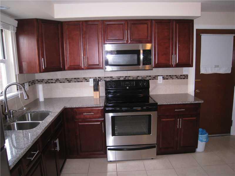 1507 Homestead Road Penn Hills, PA 15147 - Photo 2 of 17 Kitchen. The newer remodeled kitchen features ceramic tile flooring, stainless steel appliances, granite counter tops and beautiful back splash.