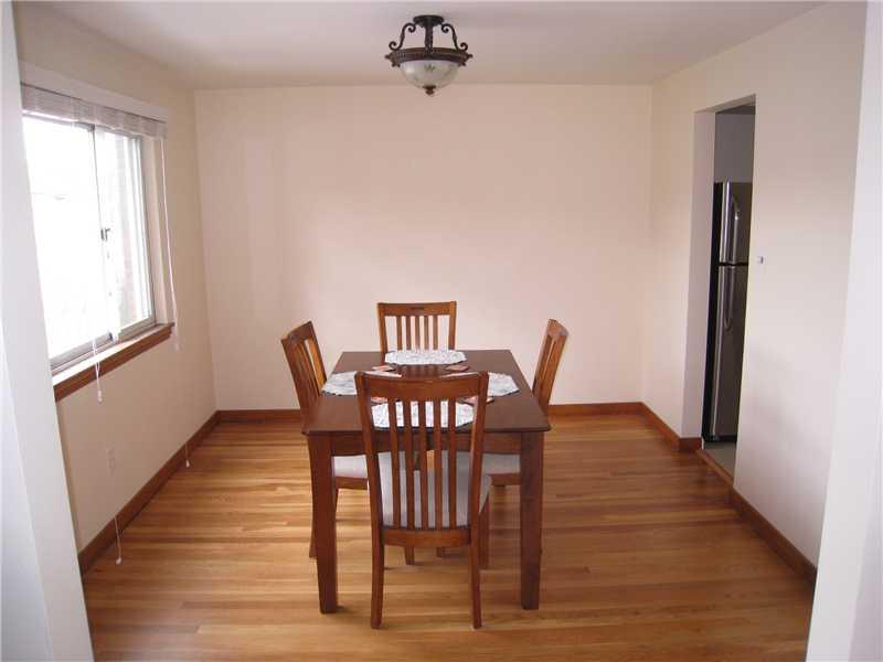 1507 Homestead Road Penn Hills, PA 15147 - Photo 7 of 17 Dining Room. An abundance of natural light flows into the dining room, also featuring refinished hardwood floors.