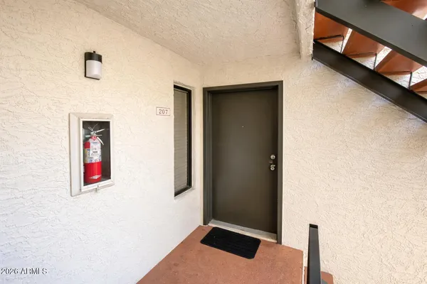 a backyard of a house with yard table and chairs