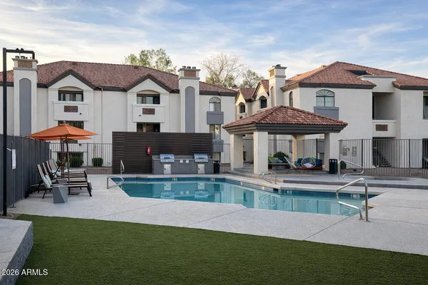 a view of a patio with swimming pool table and chairs