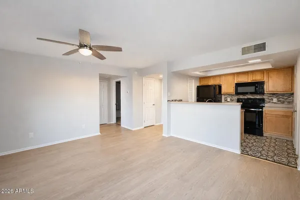 a view of a kitchen with a sink stainless steel appliances