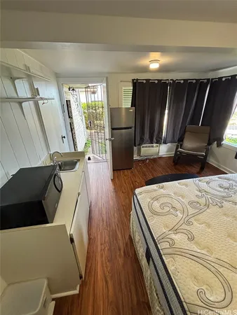 a view of a living room with furniture and wooden floor