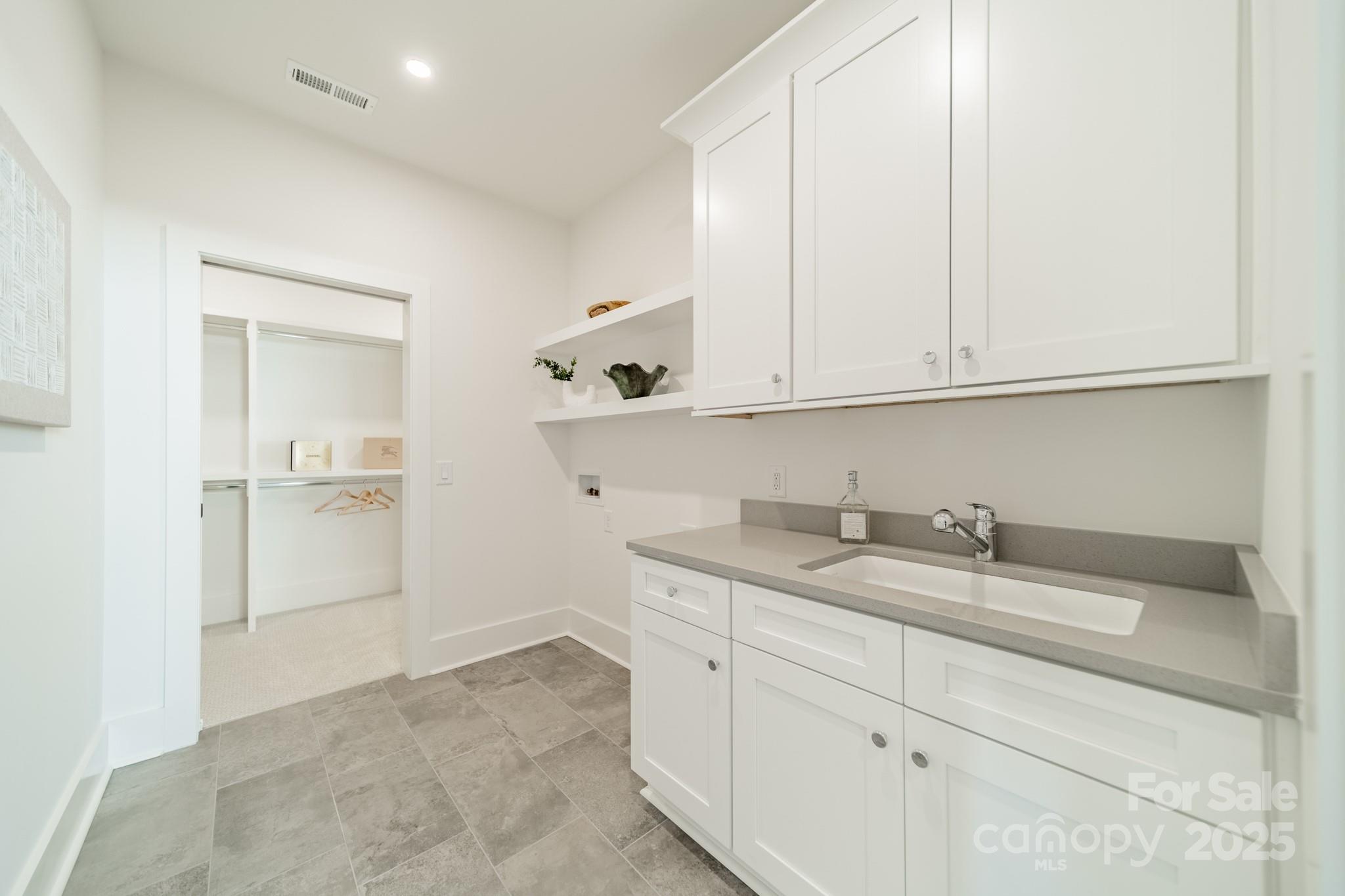 19032 Newburg Hill Road, Unit 23 Davidson, NC 28036 - Photo 22 of 39 a kitchen with a sink and cabinets
