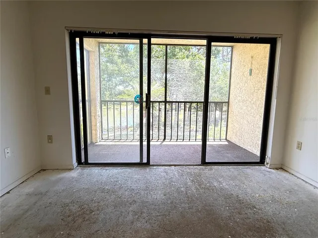 a view of an empty room with a large window