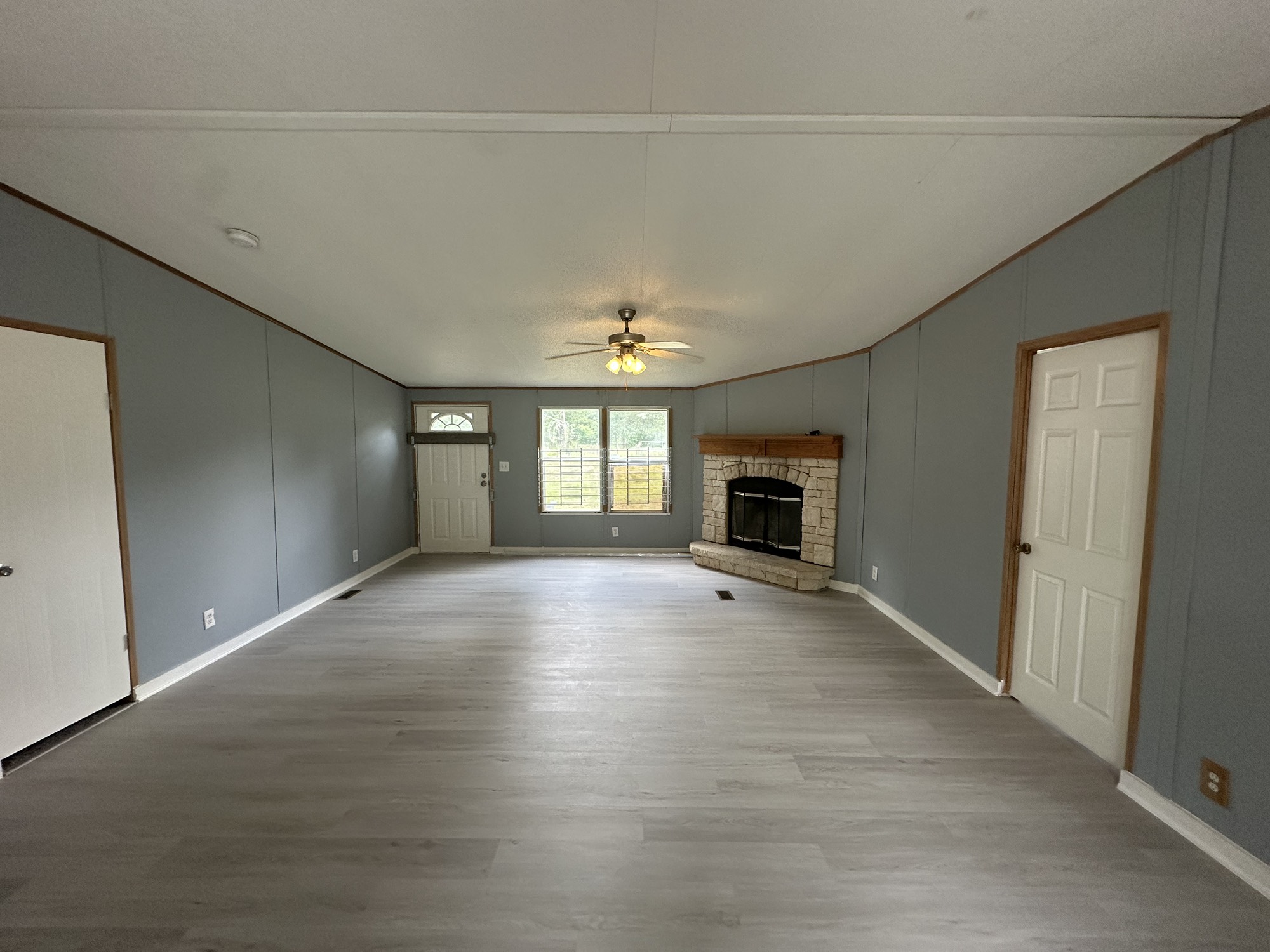 2229 Meekins Road Cleveland, TX 77328 - Photo 3 of 48 an empty room with fireplace and windows