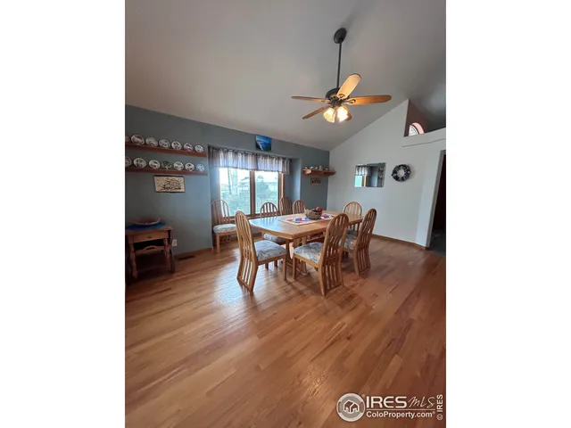 a view of a dining room with furniture and a chandelier