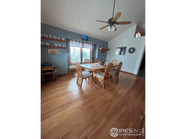 a view of a dining room with furniture and a window