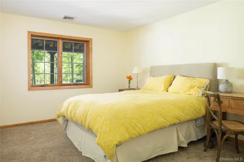 a large bed sitting in a bedroom next to a window
