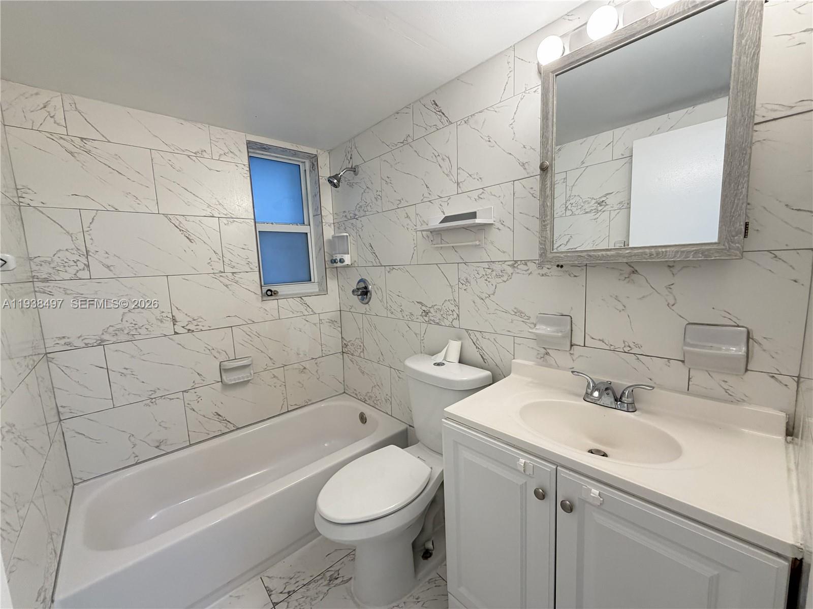 1860 Southwest 22nd Street, Unit 7 Miami, FL 33145 - Photo 1 of 8 a bathroom with a sink toilet and shower